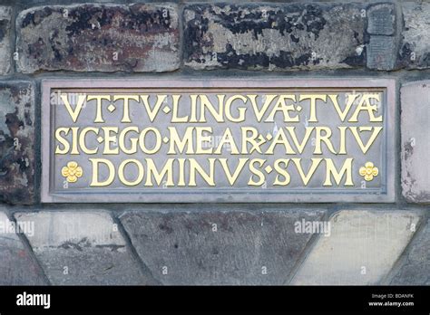 Latin Inscription Panels Set In Ancient Stone Walls The Latin Script Is Highlighted In Gold