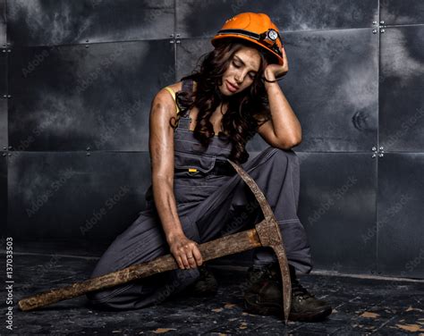 Sexy Female Miner Worker With Pickaxe In Coveralls Over His Naked Body