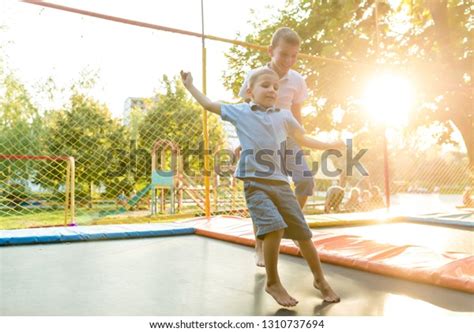 Two Boys Jump On Trampoline Cheerfully Stock Photo Edit Now 1310737694