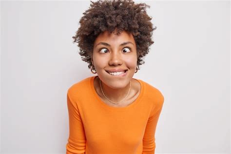 Free Photo Funny Crazy Woman With Curly Hair Crosses Eyes Bites Lips