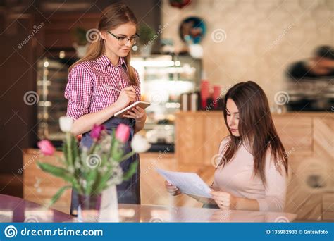 Hospitable Waitress Help To Customer What To Choose Something From Menu Stock Image - Image of ...