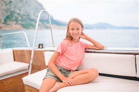Premium Photo Cute Girl Smiling And Enjoying Sailing On Boat In The