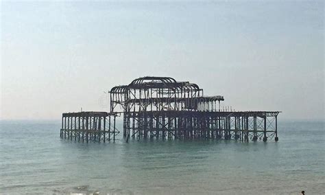 A Burnt Out Pier Off The Cost Of Brighton Stock Photo Image Of