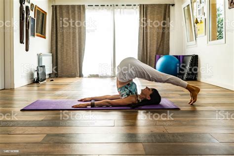Side View Of A Woman Practicing Yoga Doing Plow Pose Pose Yoga Studio