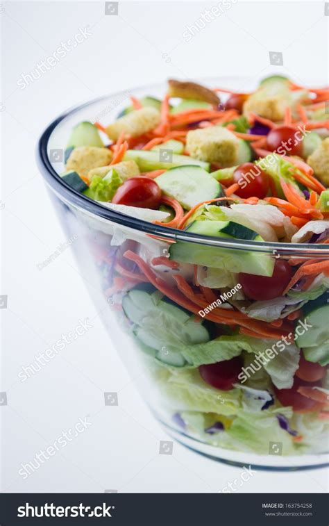 Fresh Tossed Garden Salad In A Glass Bowl Set Against A White