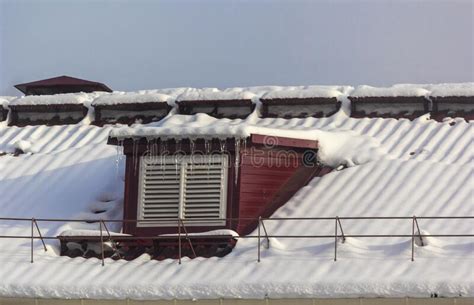 Large Icicles On The Roof Of The House On A Snowy Winter Day Roof