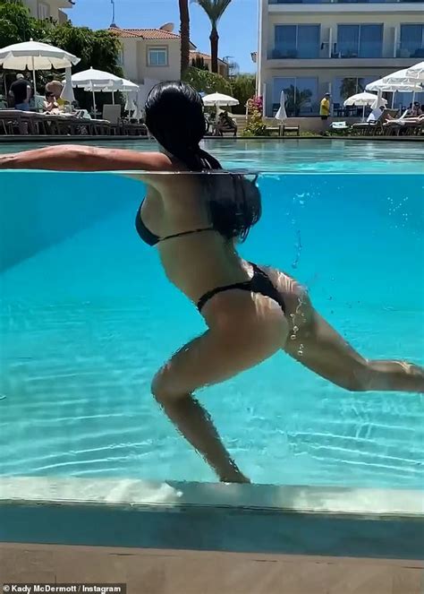 Kady McDermott flaunts her pert derrière in a black bikini for pool