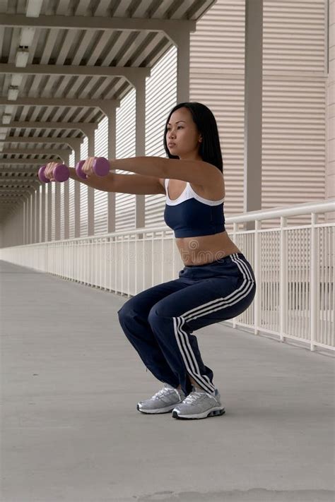 asian woman squatting with dumbbells stock image image of blue fitness 903073