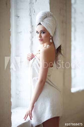 Sexy Girl With A Towel On His Head Standing Near A Window Stock Photo