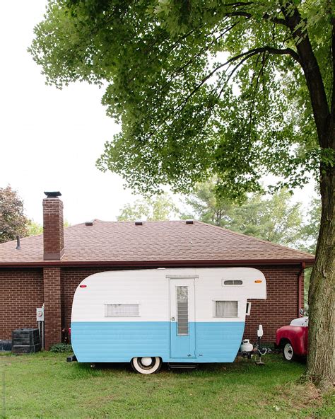 Vintage Camper Parked By House By Stocksy Contributor Brian Powell