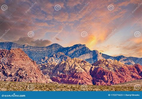 Red Rock And Blue Mountains Rising From Desert At Sunset Stock Image