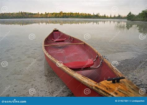 Red Canoe Beached On Lake Stock Image Image Of Glassy 31927301