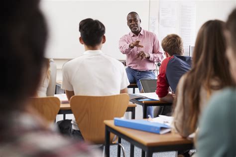 Teacher Standing At Front Of College Students For Lesson