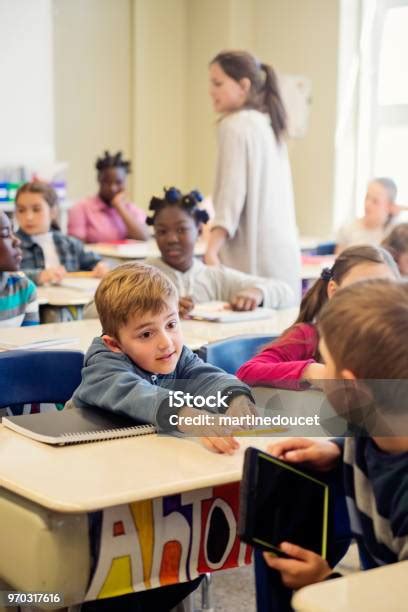 Elementary School Children Misbehaving In Classroom Stock Photo
