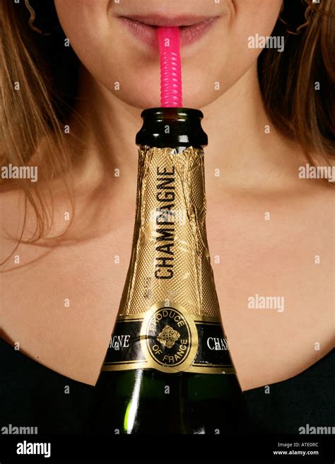 Young Woman Drinking Champagne Through A Pink Straw Stock Photo Alamy