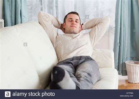 Young Man Resting On A Sofa Stock Photo Alamy
