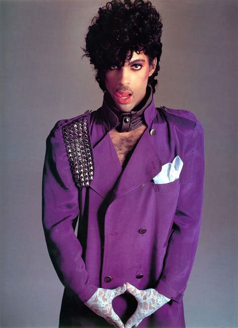A Man In A Purple Suit With Black Hair And Piercings On His Head