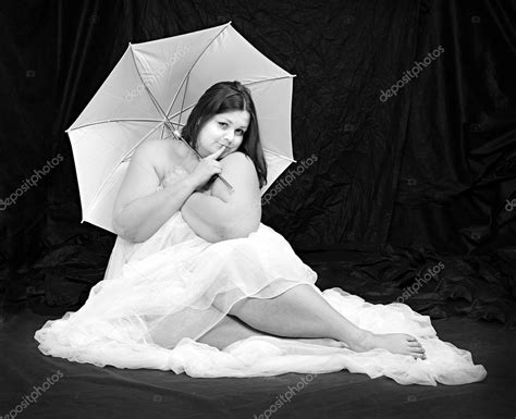 Retro Style Picture Of A Overweight Woman Posing On A Black Background
