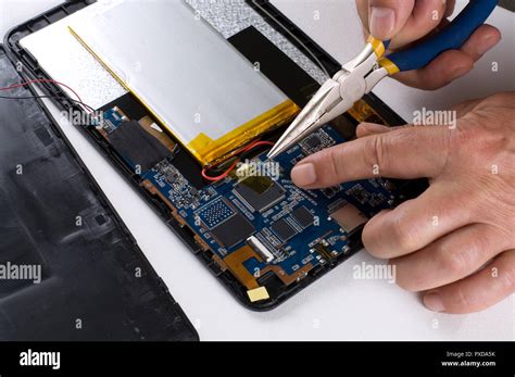 Man Fixing An Electronic Device Using Long Nose Pliers Stock Photo Alamy