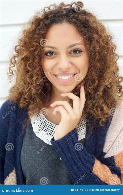 Beautiful Young Woman With Curly Hair Smiling Outdoors Stock Photo