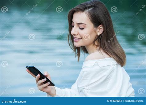 Girl Outdoors Texting On Her Mobile Phone Girl With Phone Portrait Of A Happy Woman Text Sms