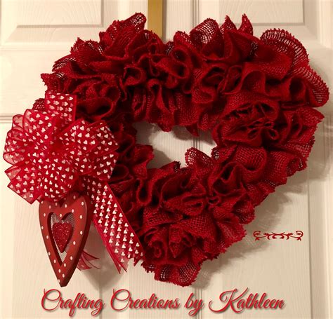 A Heart Shaped Wreath With Red Mesh And Polka Dots Hangs On The Front