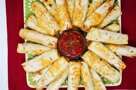 These chicken flautas are filled with chicken, salsa, and cheese and baked in the oven until crispy. Baked Cheesy Chicken Flautas | Grace Like Rain Blog
