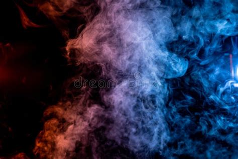 Red And Blue Smoke Cloud Wisps Over A Black Background Stock Photo