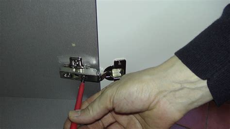 Door removal release the lever under the hinge arm to remove. How to adjust kitchen door hinges - A Video Guide