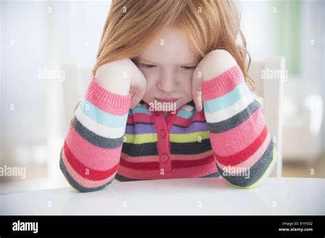 Caucasian Girl Crying At Table Stock Photo Alamy