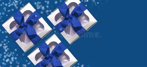 Silver Metallic T Box With A Blue Ribbon Bow Isolated On White