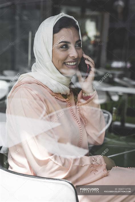 Moroccan Woman With Hijab And Traditional Arabic Dress Talking On Phone