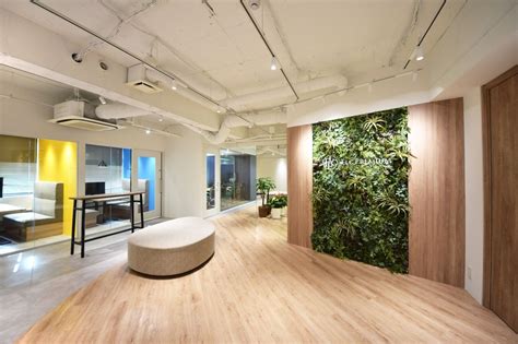 An Office With Wood Floors And Plants On The Wall