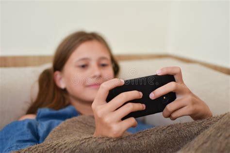 Girl Lies On Couch With Phone Teenager Girl Playing On Smartphone