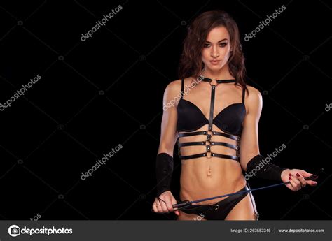 Sensual Provocation Of A Sexy Woman With Whip On Black Background BDSM