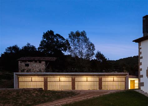 Green-roofed concrete outbuilding is an extension of the rural Spanish