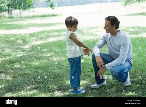 Boy And Father Talking Outdoors Stock Photo Alamy
