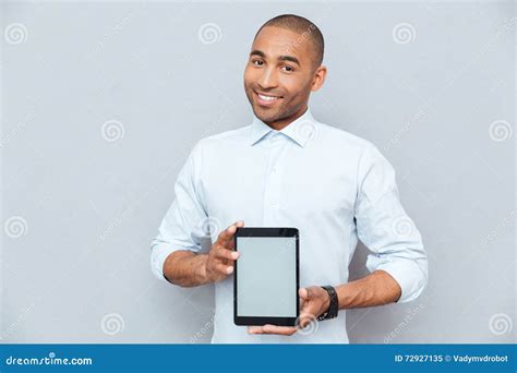Smiling Attractive African American Young Man Holding Blank Screen