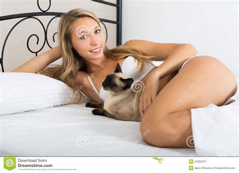 Siamese cats are one of the more popular domesticated cat breeds, along with being one of the most recognizable and widely known cats in the world. Beauty Long-haired Woman With Siamese Cat Stock Photo ...