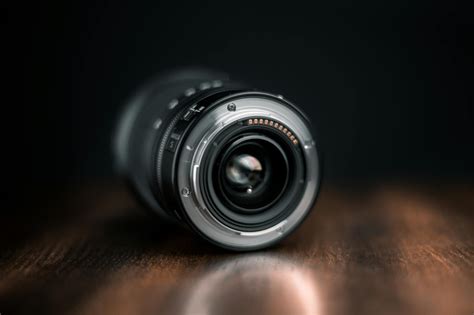 Selective Focus Photography Of Camera Lens On Wooden Surface · Free