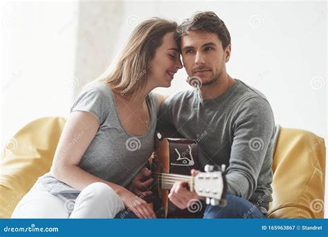 Cute Young People Playing On Acoustic Guitar For The Girlfriend In The