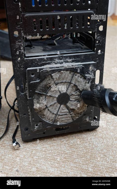 Cleaning The System Unit Of A Desktop Computer From Dust With A Vacuum