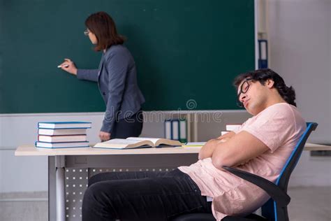 Old Female Teacher And Male Student In The Classroom Stock Image
