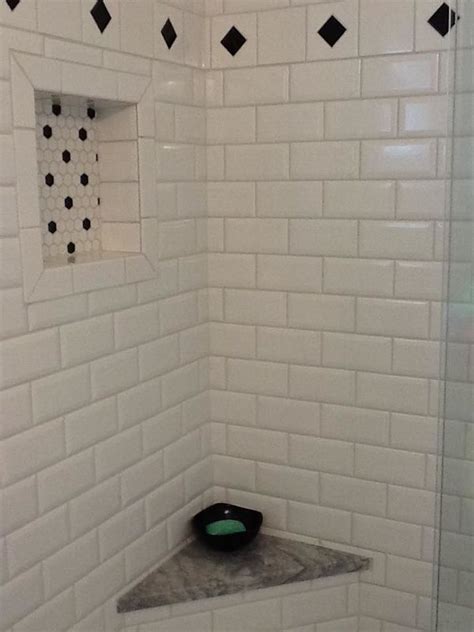 Maybe you would like to learn more about one of these? White subway tile shower with black accents, black & white ...