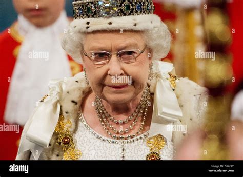Queen Elizabeth Ii Wearing The Imperial State Crown Walks Through The