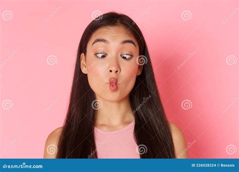 beauty fashion and lifestyle concept portrait of funny and playful silly asian girl squinting