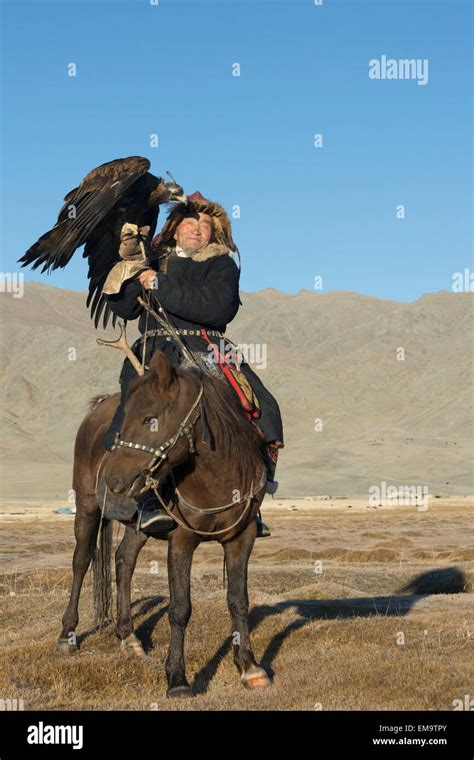 Elder Kazakh Eagle Hunter Posing With His Eagle And His Horse 3