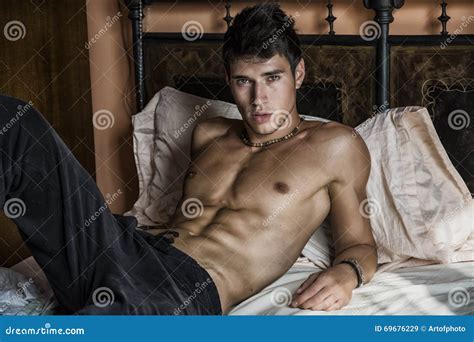 Shirtless Male Model Lying Alone On His Bed Royalty Free Stock Image Cartoondealer Com