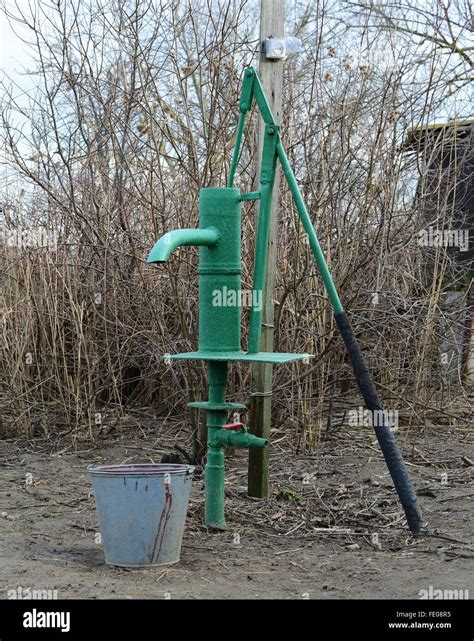 Hand Pump Leading To An Artesian Well Pumping Water For Watering The