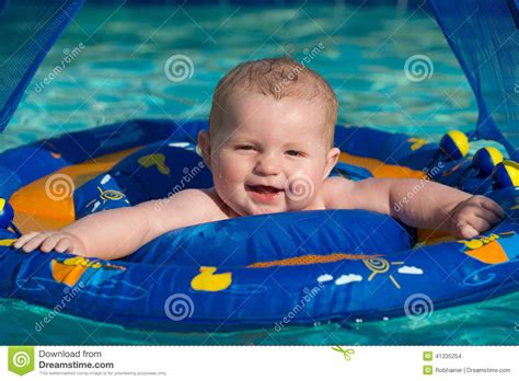 This pool float from laycol allows your baby to sit either facing forward or backward. Happy Infant Playing In Pool While Sitting In Baby Float ...